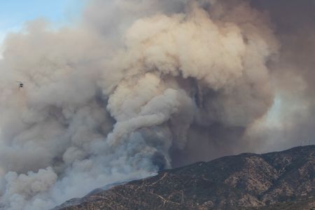 Bell UH-1 Huey flying out of the Canyon Fire after making a water drop Canyon Fire