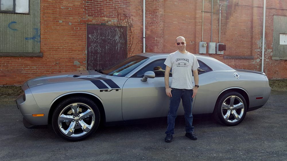 Photo of Joe standing next to his 2011 Dodge Challenger R/T Classic Billet Silver Metallic 5.7L Hemi Super Track Pak Challenger Joe