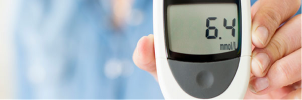 Man Holding a Glucometer