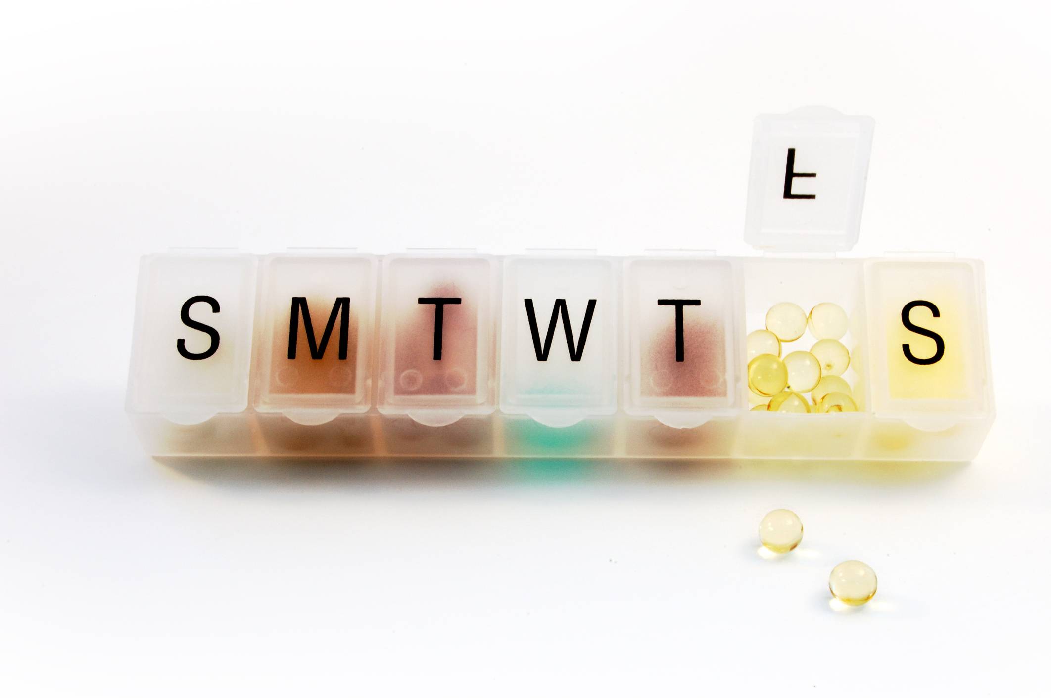 Pill organizer with pills inside. Medication Adherence