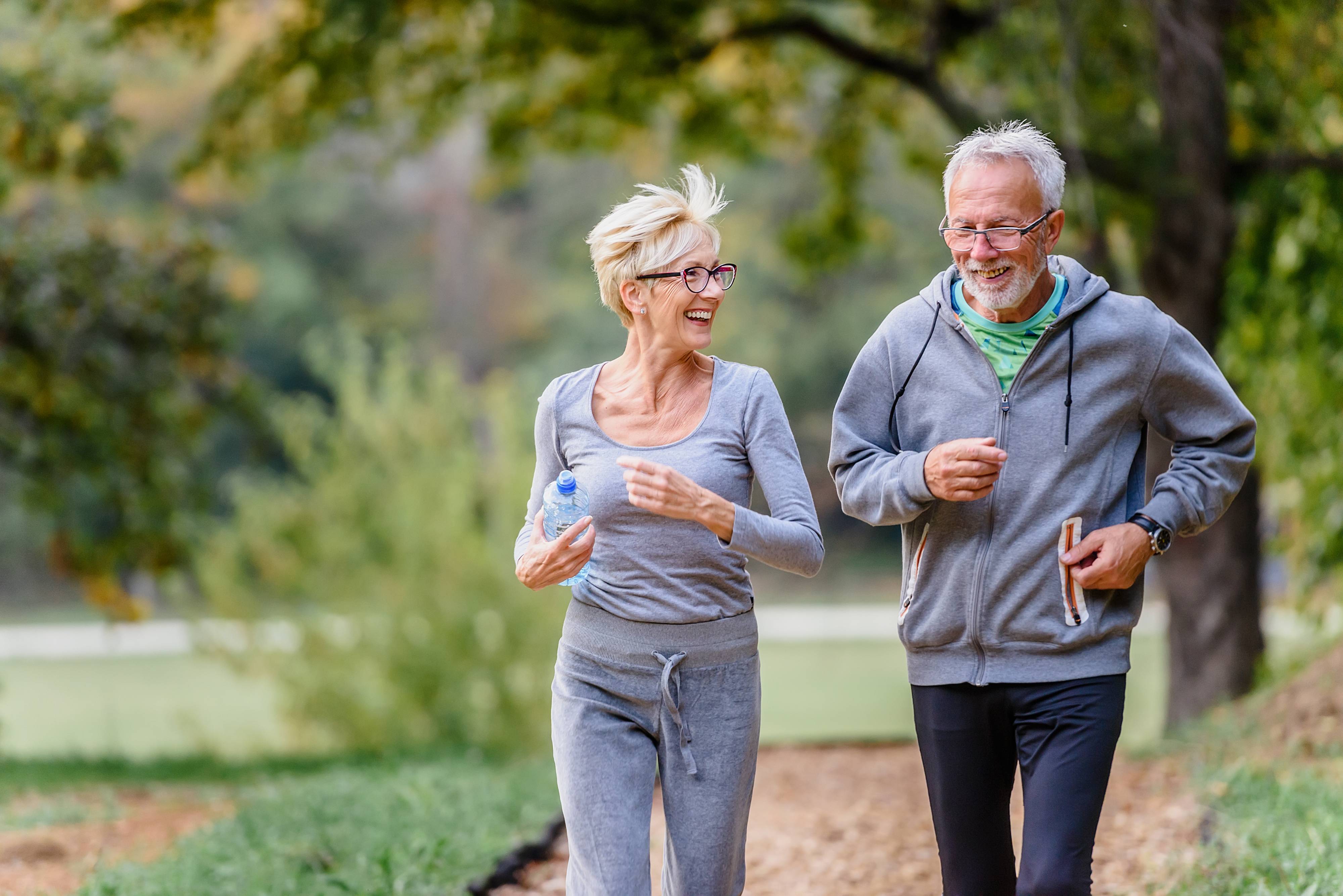 Older couple jogging together Medicare Open Enrollment