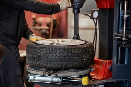auto-mechanic-working-with-service-equipment-vulcanizing-car-tire.jpg