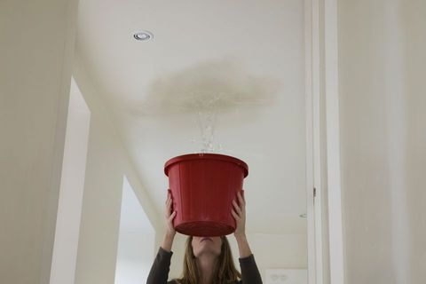 woman-holding-out-a-bucket-to-stop-a-roof-leak-106958449-5910d02c5f9b5864703afaa8.jpg