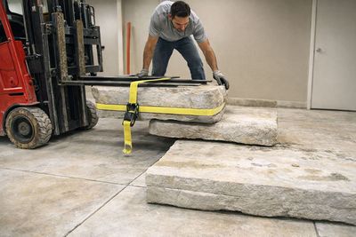 Forklift loading heavy concrete slabs for disposal