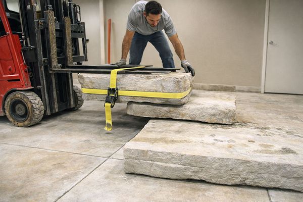 Forklift loading heavy concrete slabs for disposal