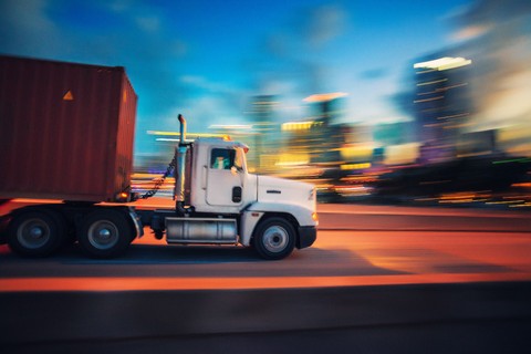 Truck transporting a shipping container