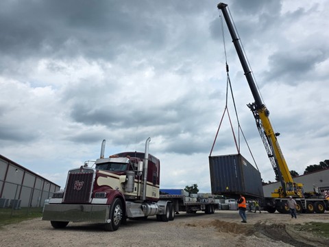 crane lifting blue container