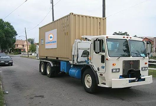Sidelifter truck transporting shipping container