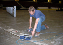 Jamie Althauser from GPRS, Inc. is mapping glycol pipe locations
onto the concrete floor at Quicken Loans Arena in Cleveland. glycol-pipes-pic1.jpg