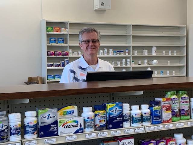 Click here to learn more about our pharmacy services Pharmacist behind counter