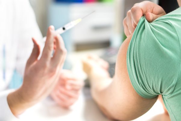 a person receives a shot in their arm Immunizations