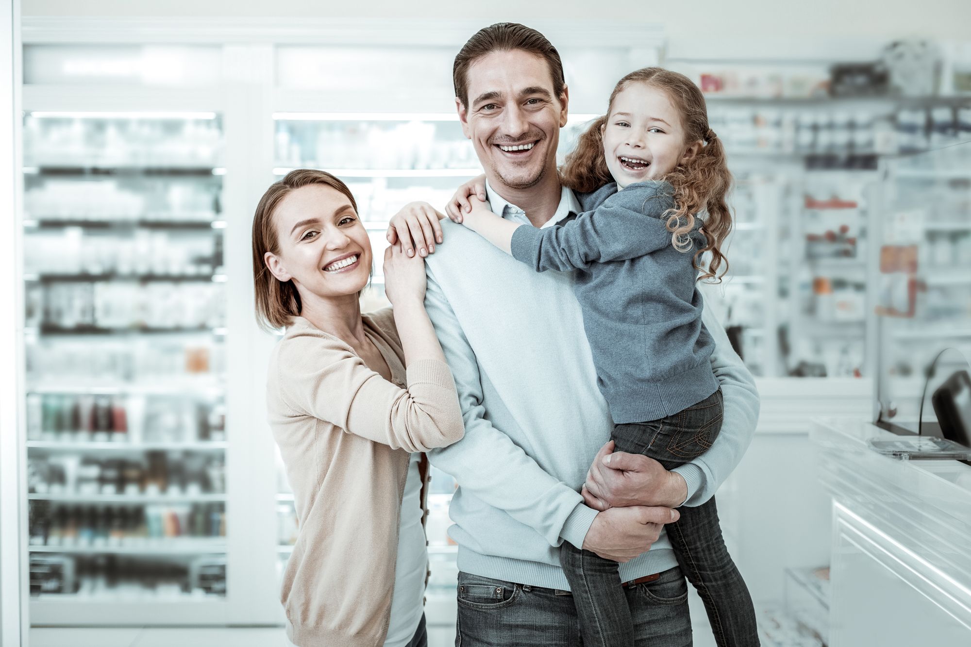 Family cuddles in pharmacy