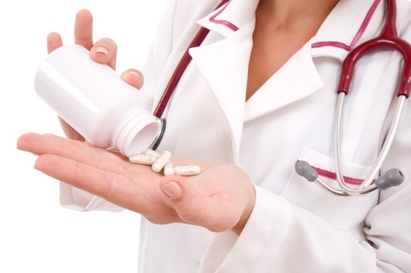 Image of a healthcare professional getting medication from bottle Medication Therapy Management