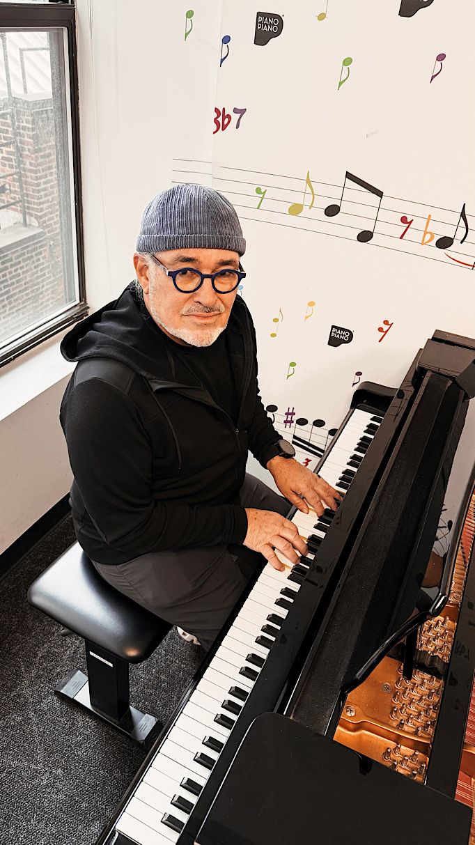 Jour Majesty is in a piano studio playing a grand piano  in New York City