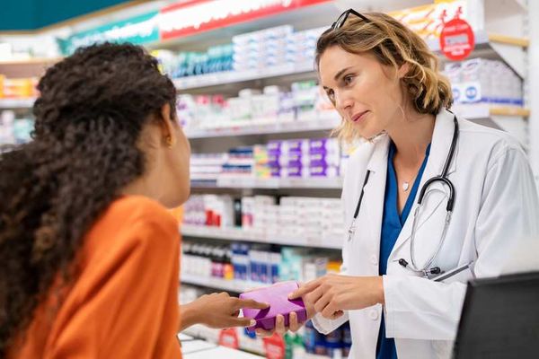 Pharmacist explaining medication to customer