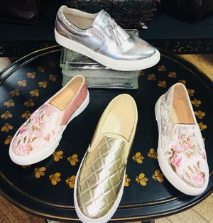 Table displaying four different shoes for women Harvest Drug and Gift shop items