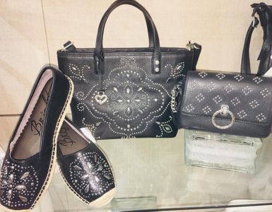 Closeup of two black bejeweled purses next to black bejweled flat shoes Harvest Drug and Gift shop items