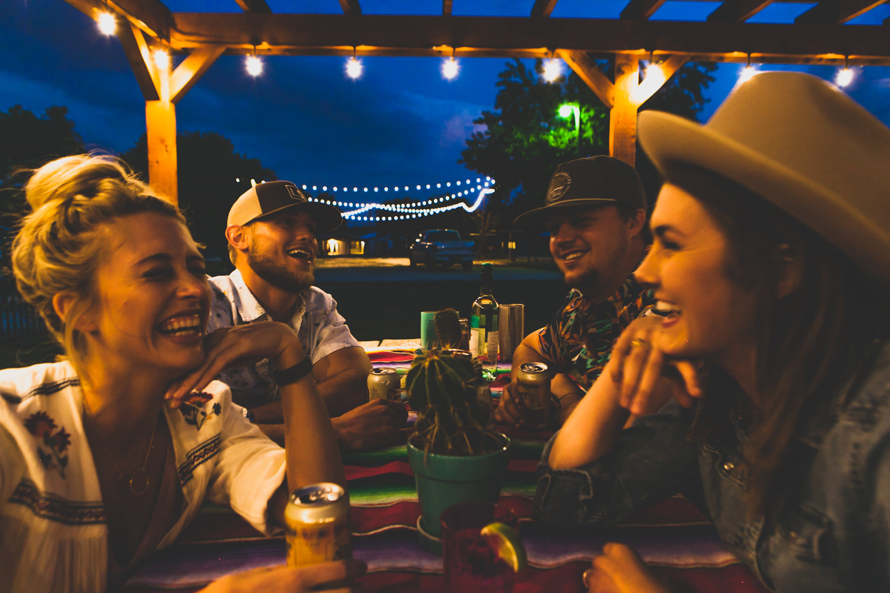Friends at a picnic table at night guadalupe river cabins