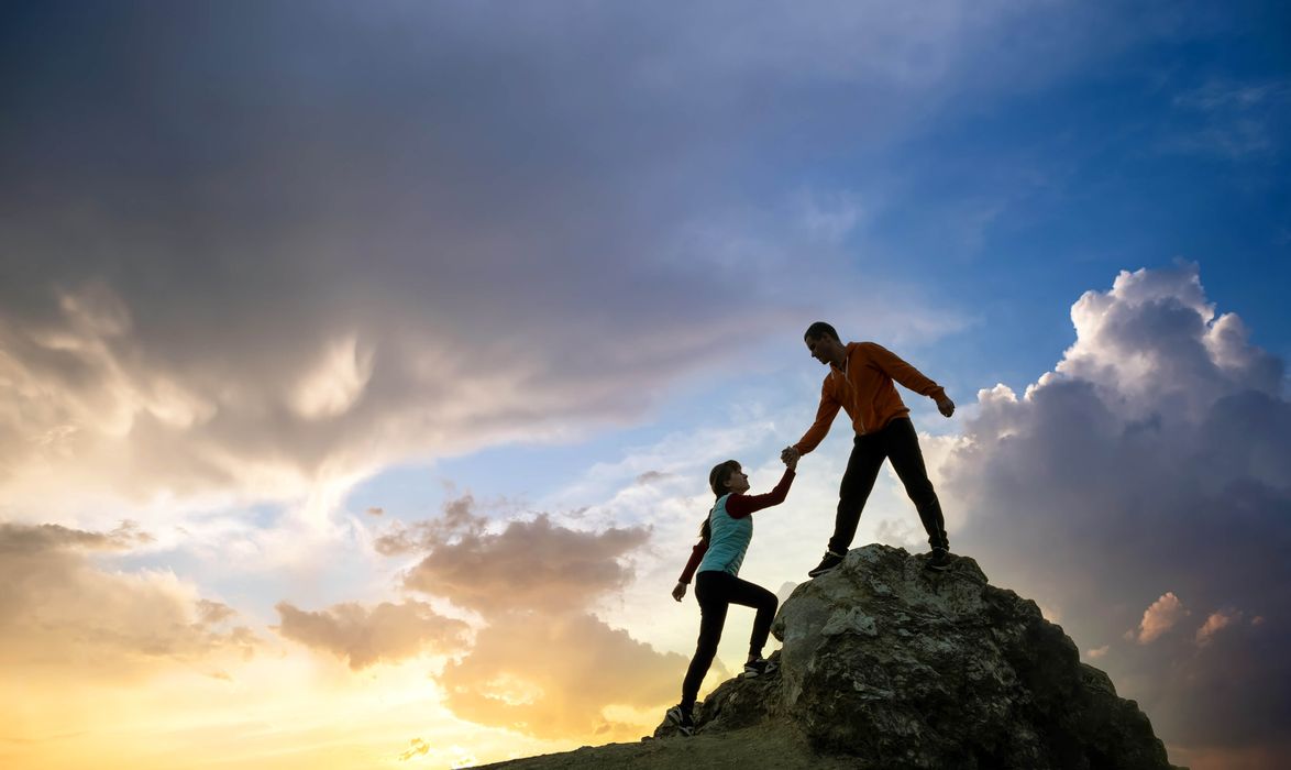 man-and-woman-hikers-helping-each-other-to-climb-a-2024-12-06-04-16-41-utc.jpg