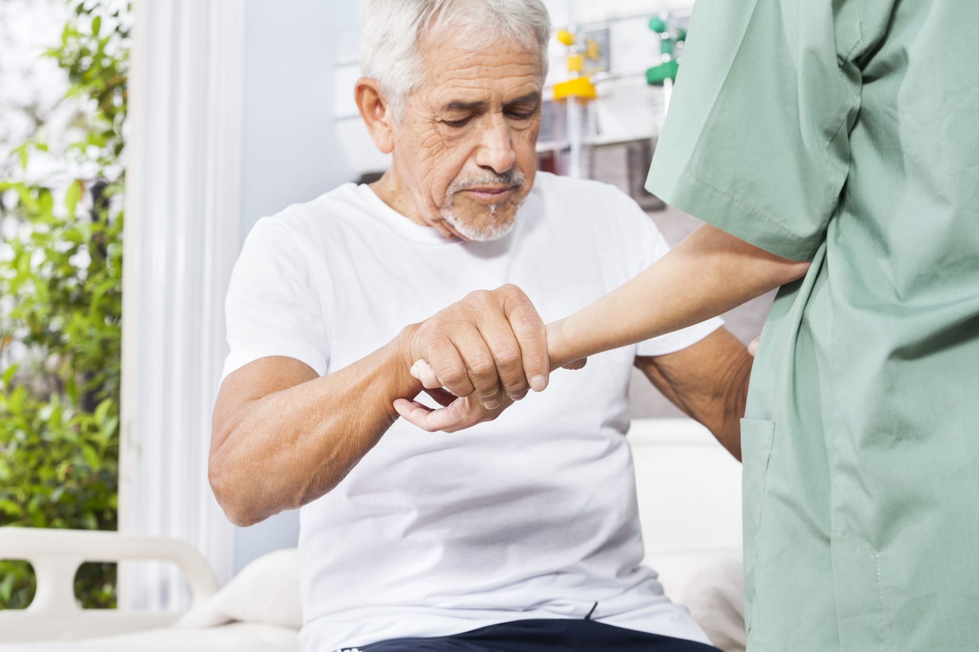 An elderly man being assisted by a healthcare professional during a wellness check. Senior Receiving Medical Care