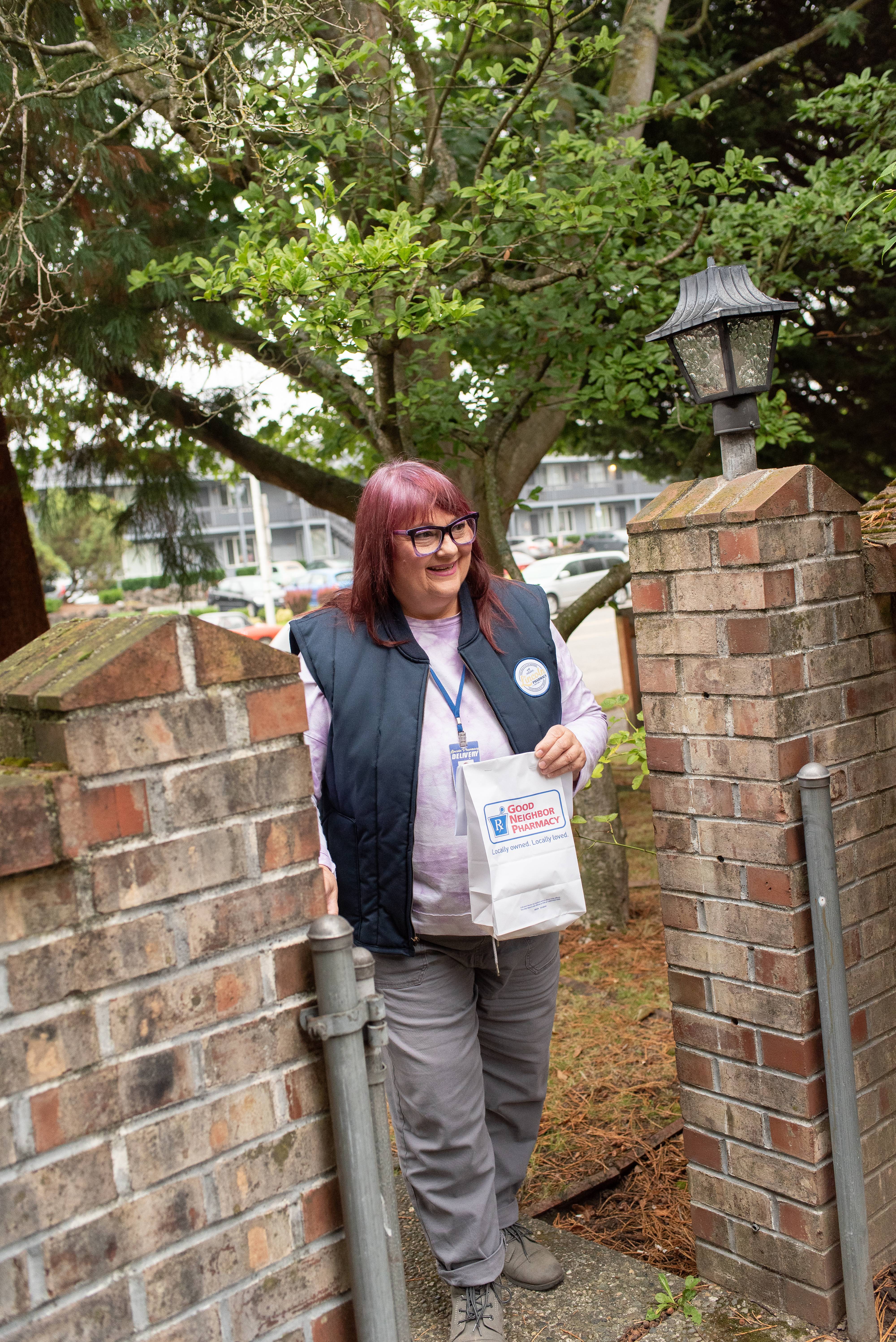 Image of a Lincoln Pharmacy Employee handing out package Home Delivery