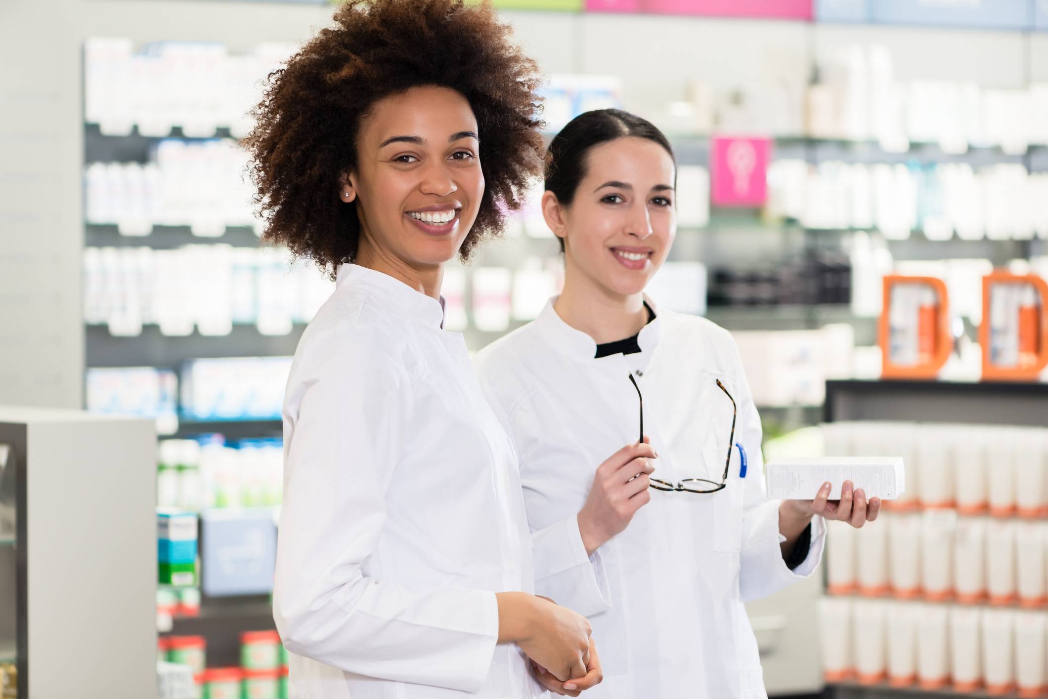 Portrait of a African-American pharmacist next to her colleague