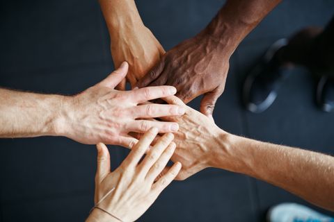 diverse-people-standing-with-their-hands-together-2021-04-02-21-43-12-utc.jpg