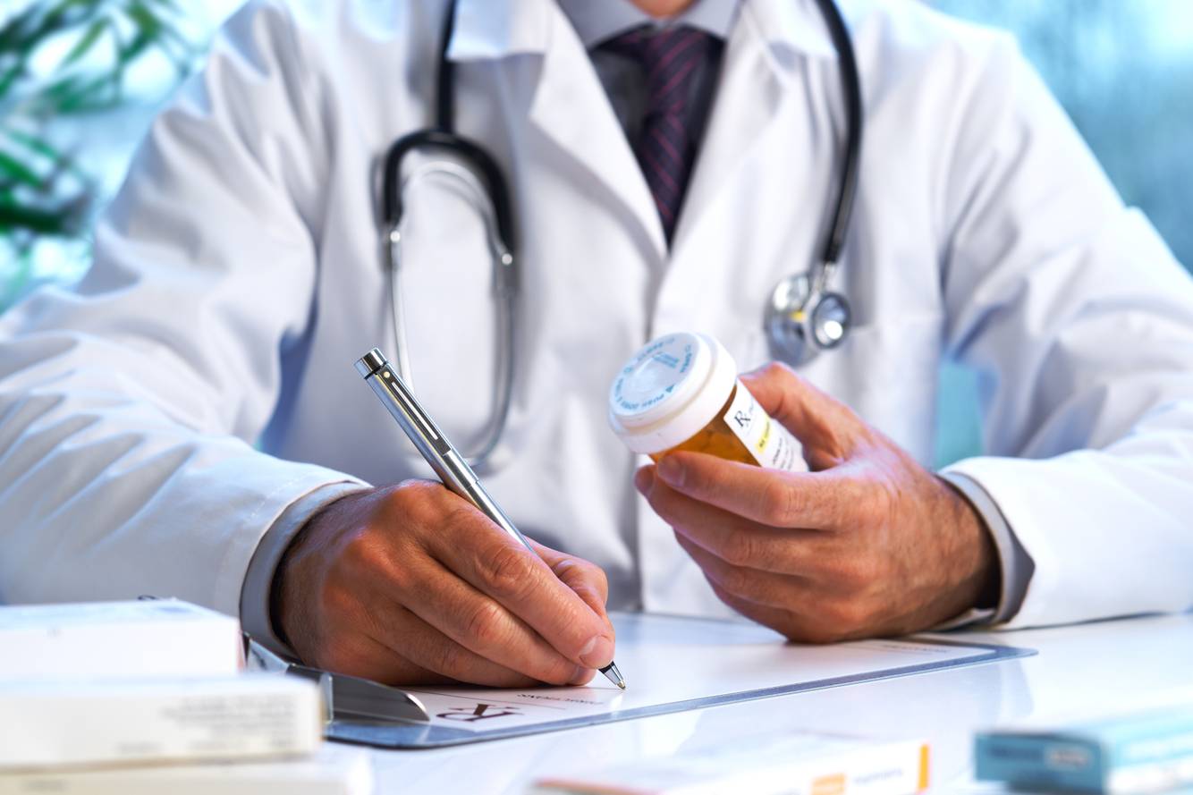 Image of a healthcare professional checking a refilled medication Medication Therapy Management