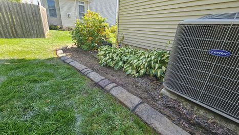 Stamped Concrete Landscape Edging Along Home Foundation