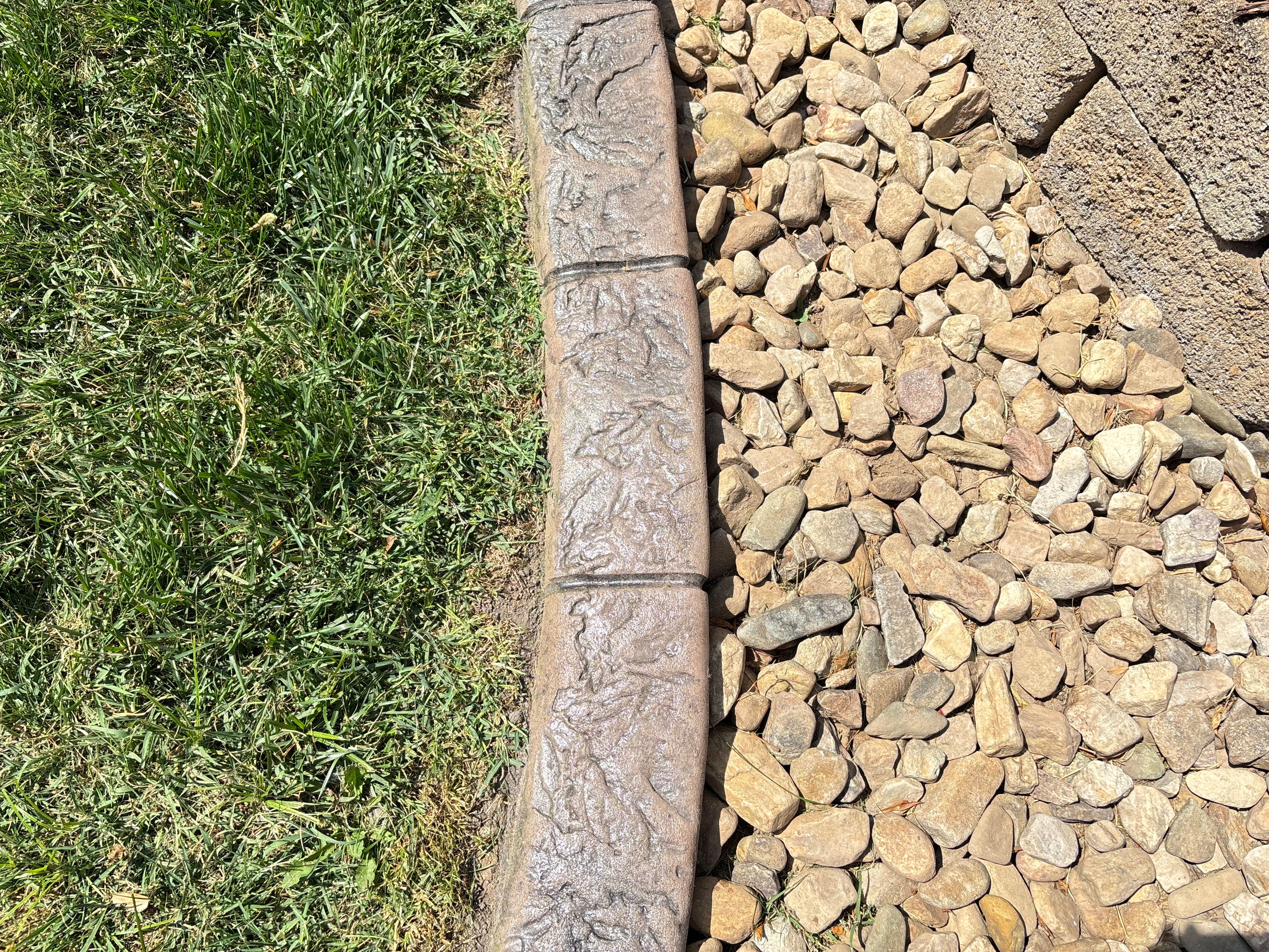 Stamped Concrete Landscape Curbing With River Rock Border