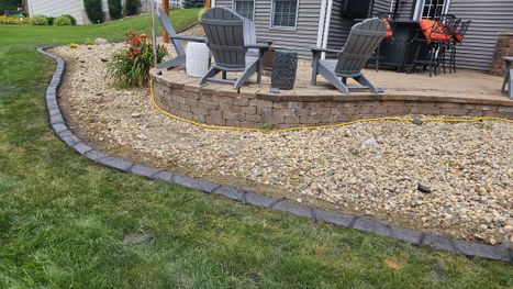 Stamped Concrete Edging With Decorative Stone Near Backyard Patio