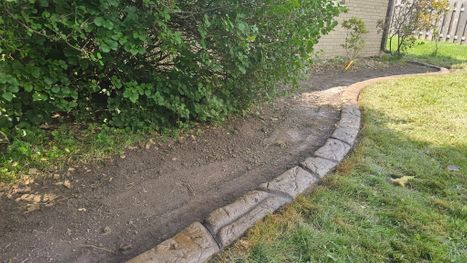 Stamped Concrete Edging With Decorative Stone Near Backyard Patio