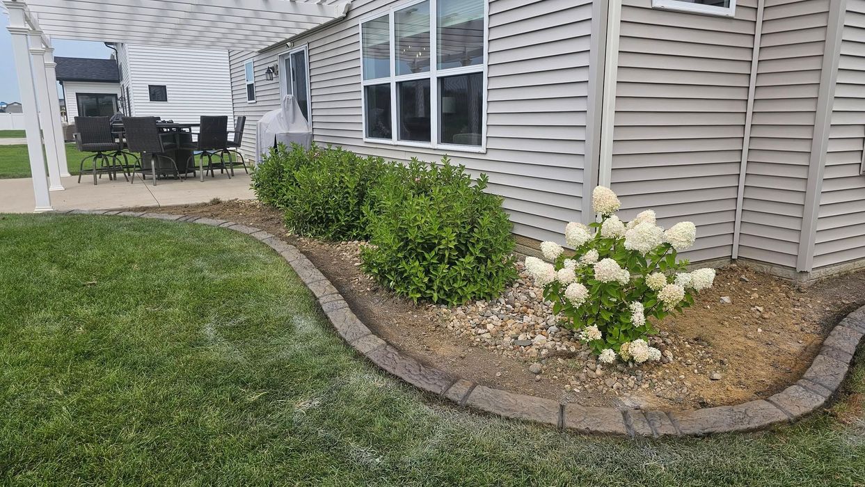 Curved Concrete Landscape Edging Around Shrub Bed and Patio