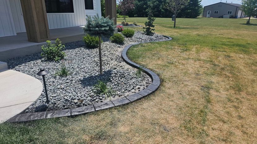 Stamped Concrete Landscape Edging With Rock Bed