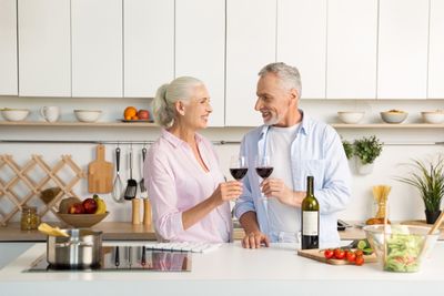 mature-happy-loving-couple-standing-kitchen-drinking-wine.jpg