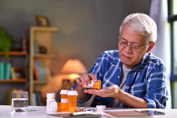 Elderly man taking pill