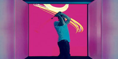 Man Swinging Golf Club in Front of an LED Video Wall 