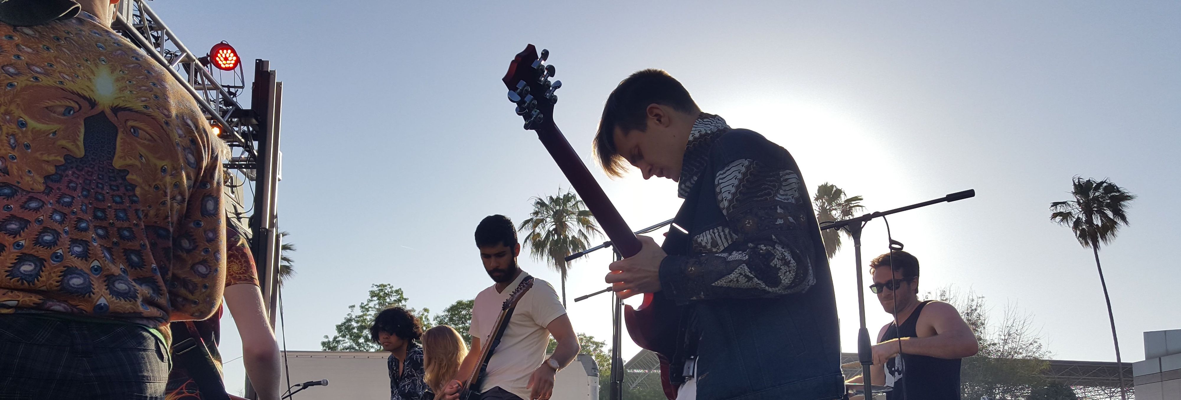 Guitar player performing at an outdoor concert 