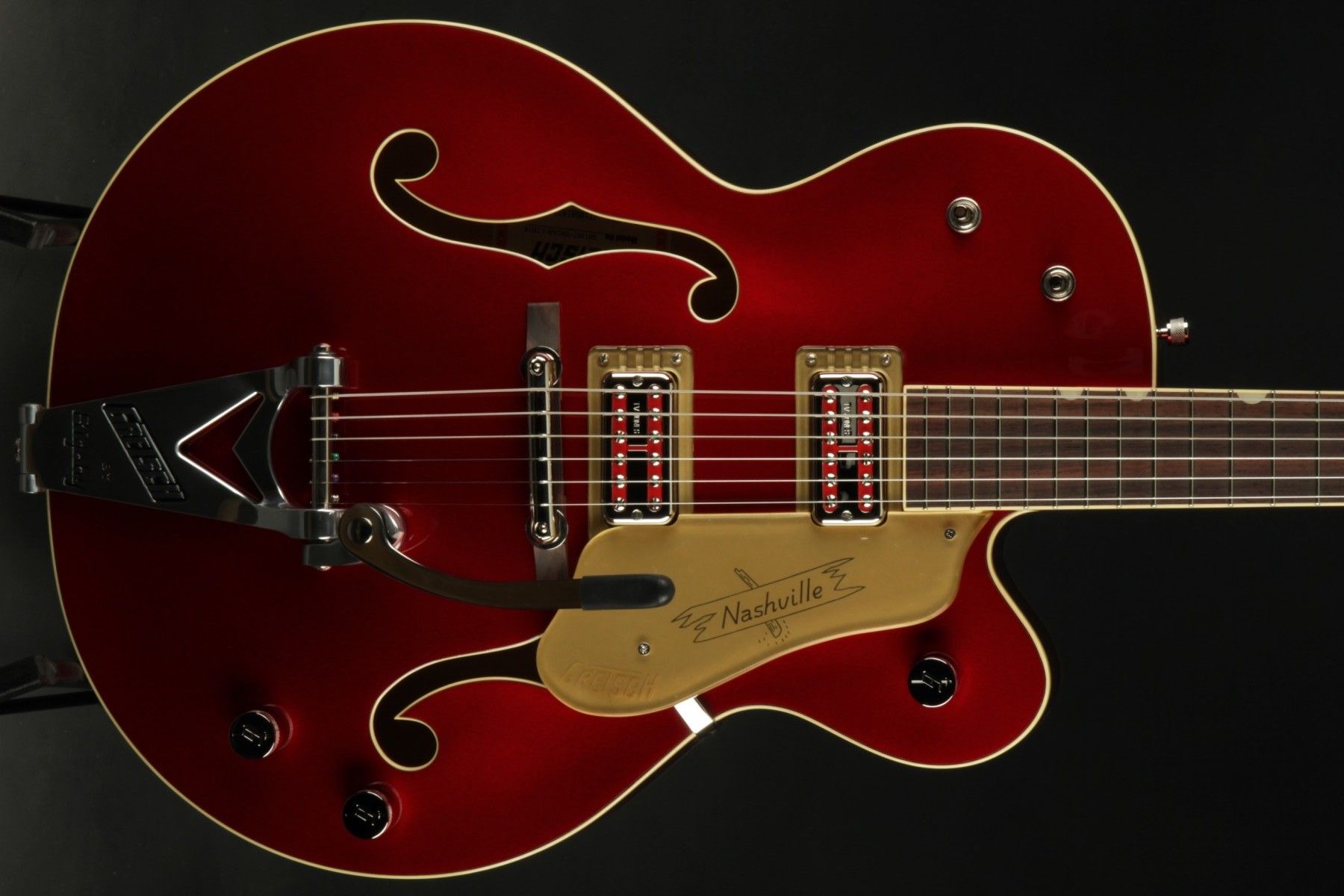 Close up of a red and gold electric guitar