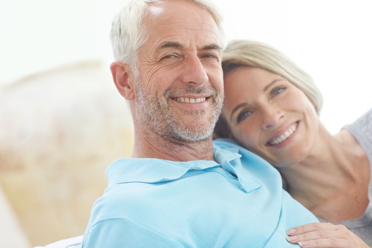 senior-couple-retirement-portrait-their-home-with-love-care-support-from-life-insurance-commitment-man-woman-healthy-happy-marriage-with-security-living-room-couch.jpg