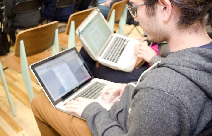 Metis data science students working on laptop computers. Metis Header.jpg