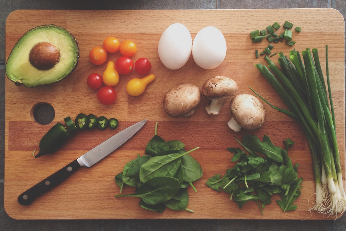 meal ingredients - vegetables and knife on chopping board Coding bootcamp meal plan.png