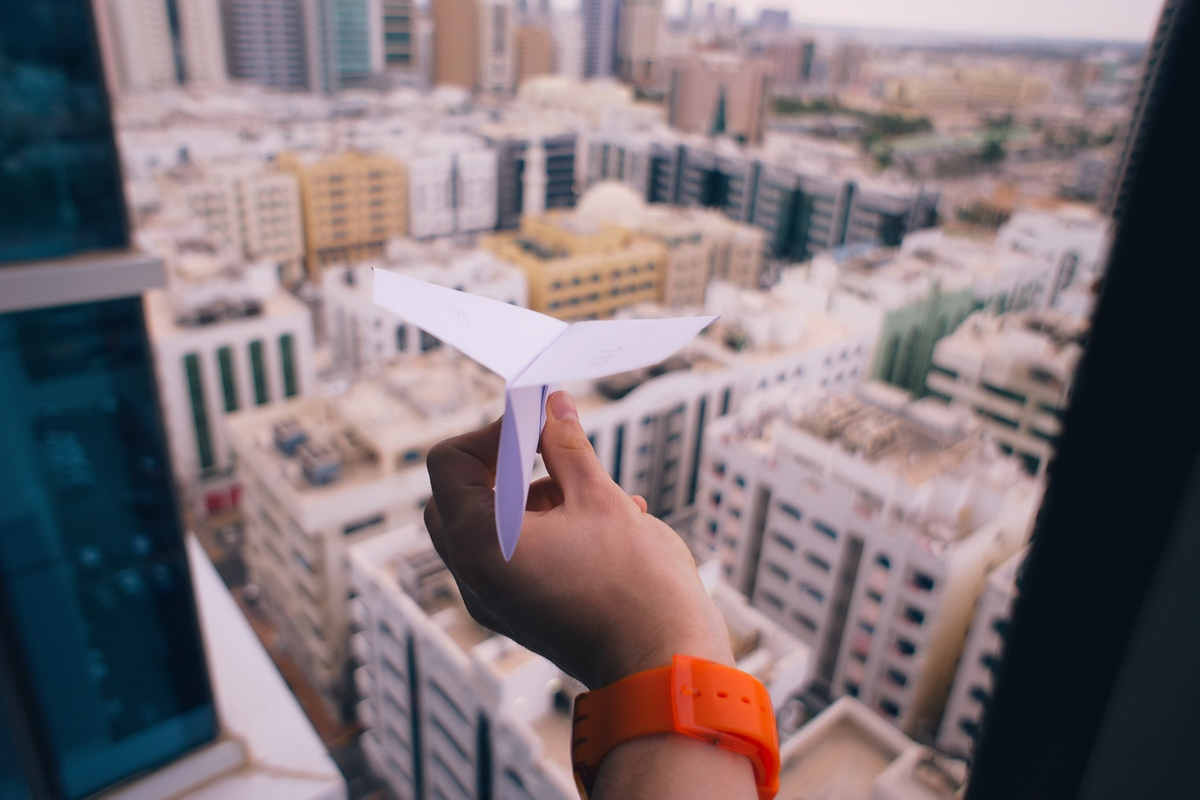 Paper airplane looking over city buildings How to Change Your Career