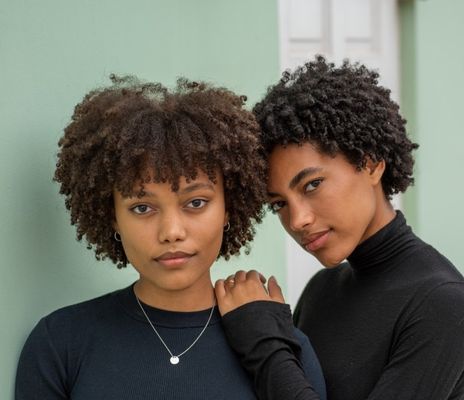 close-up-portrait-of-sisters-with-curly-hair_t20_Nxa0Qn.jpg