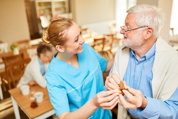 Older man being helped with a nurse. Long Term Care Pharmacy