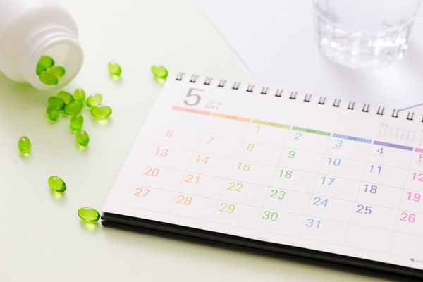 Calendar sitting next to spilled medication. Scheduled Appointments