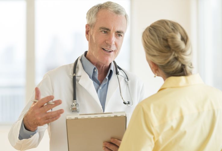Pharmacist talking to a patient POC Testing
