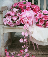 Pink roses on white bench wedding planners pink roses