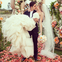 Rose petals accent this bride and groom's special moment. wedding planner bride and groom's first kiss