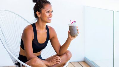 Woman enjoying a smoothie on her balcony